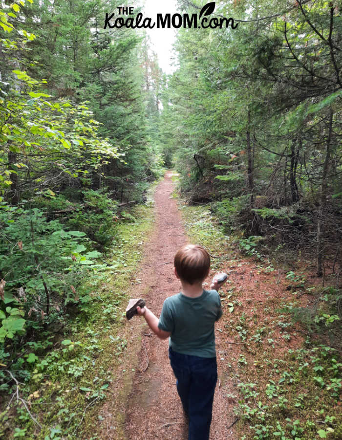Toddler walking along the trail towards West Lake Loop.