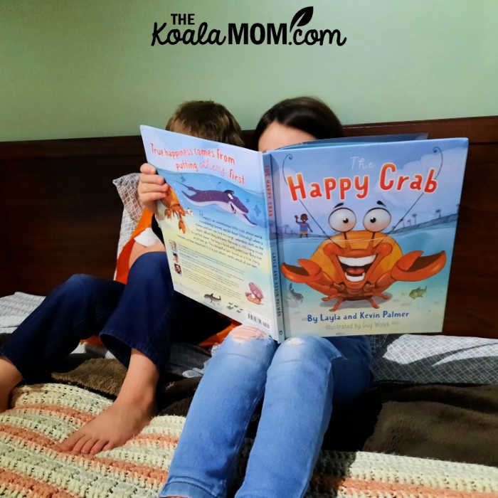 Two siblings reading The Happy Crab together.