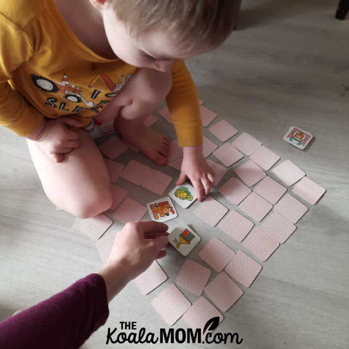 Toddler and his mom playing a memory matching game.
