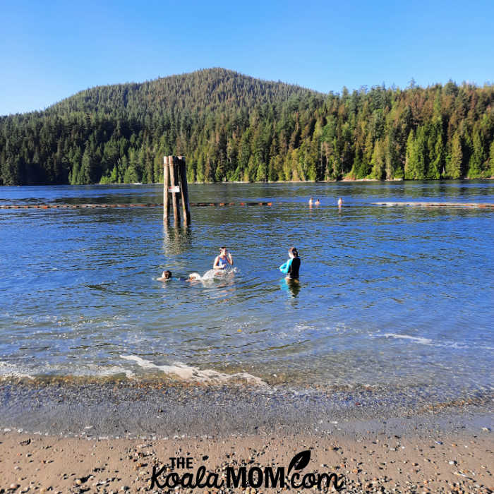 Kids swimming together at the beach.