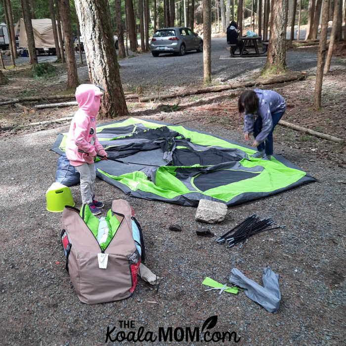 Dismantling a tent with kids.