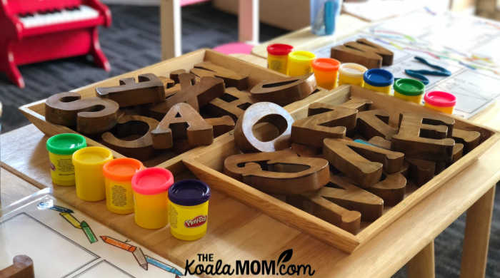 A box of wooden letters and play dough for preschoolers. Photo by Gautam Arora on Unsplash.