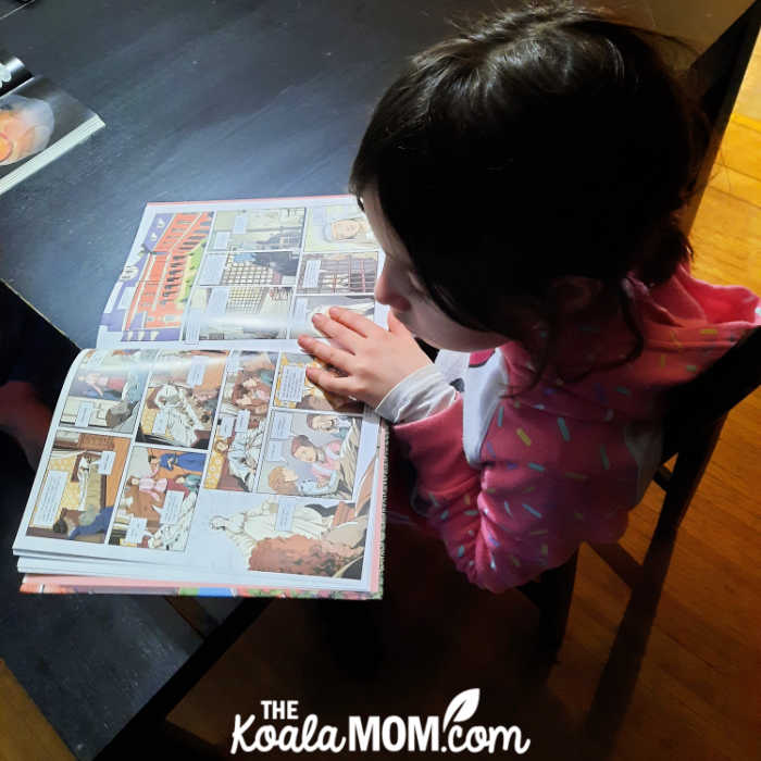 Girl reading a graphic novel about St. Therese of Lisieux.