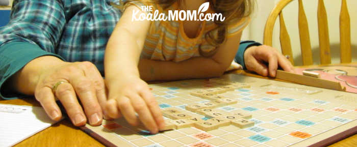 Grandma and toddler playing Scrabble together.