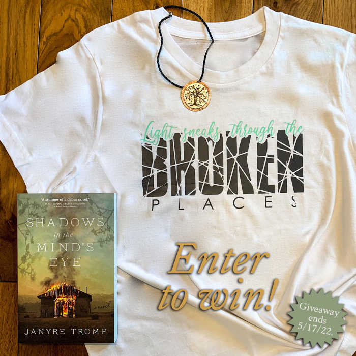 A copy of Shadows in the Mind's Eye, - A custom made silver peach tree necklace inspired by the book, - A "Light speaks through the broken places" t-shirt also inspired by the book.
