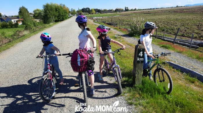 4 girls looking around on their 4-km bike ride along the West Dyke Trail.