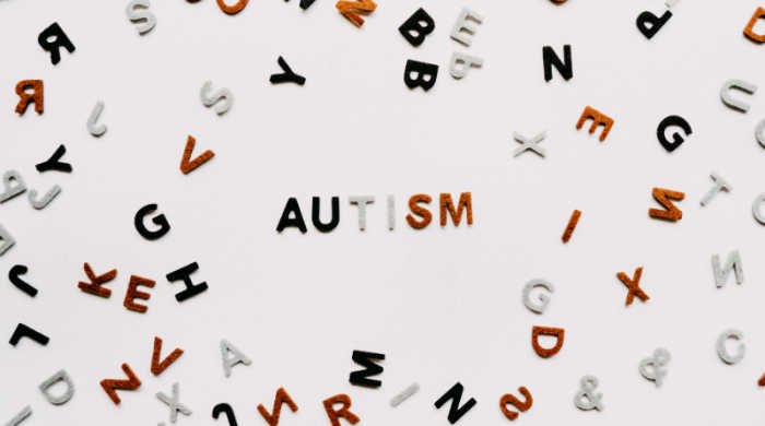Scattered letters of the alphabet, spelling AUTISM. Photo by Annie Spratt on Unsplash