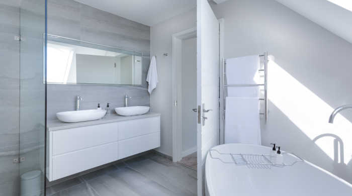 Modern white bathroom with two sinks. Photo by Jean van der Meulen on Pexels.