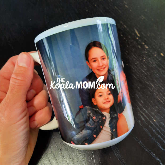 Woman holding a custom photo coffee mug.