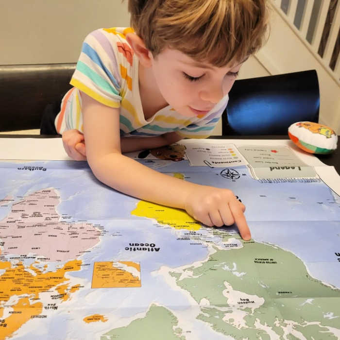 Child looking at a world map. Photo courtesy of Darya Yatskova.