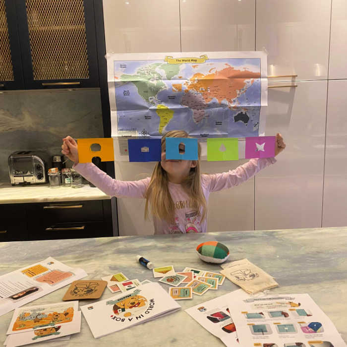 Child making papel picado banners with her World in a Box subscription box. Photo courtesy of Darya Yatskova.