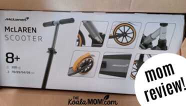 A mom reviews a McLaren scooter carefully packaged in its box for shipping.