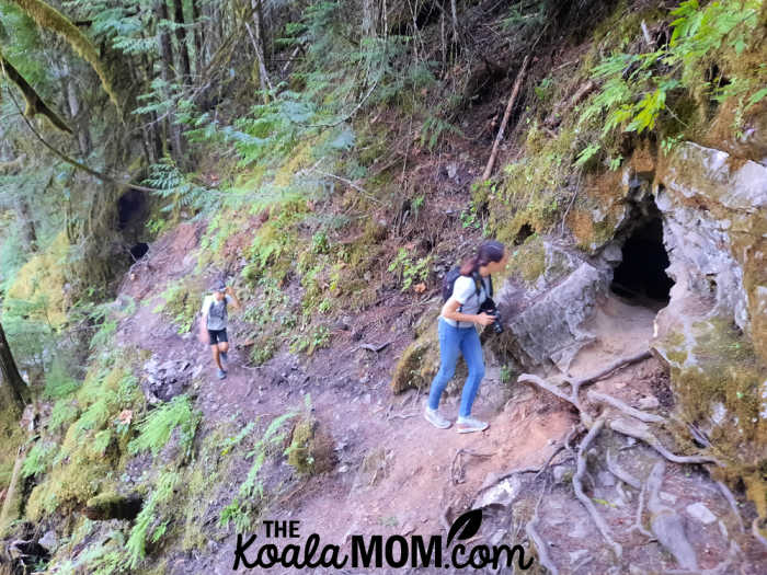 Kids exploring two caves entrances.