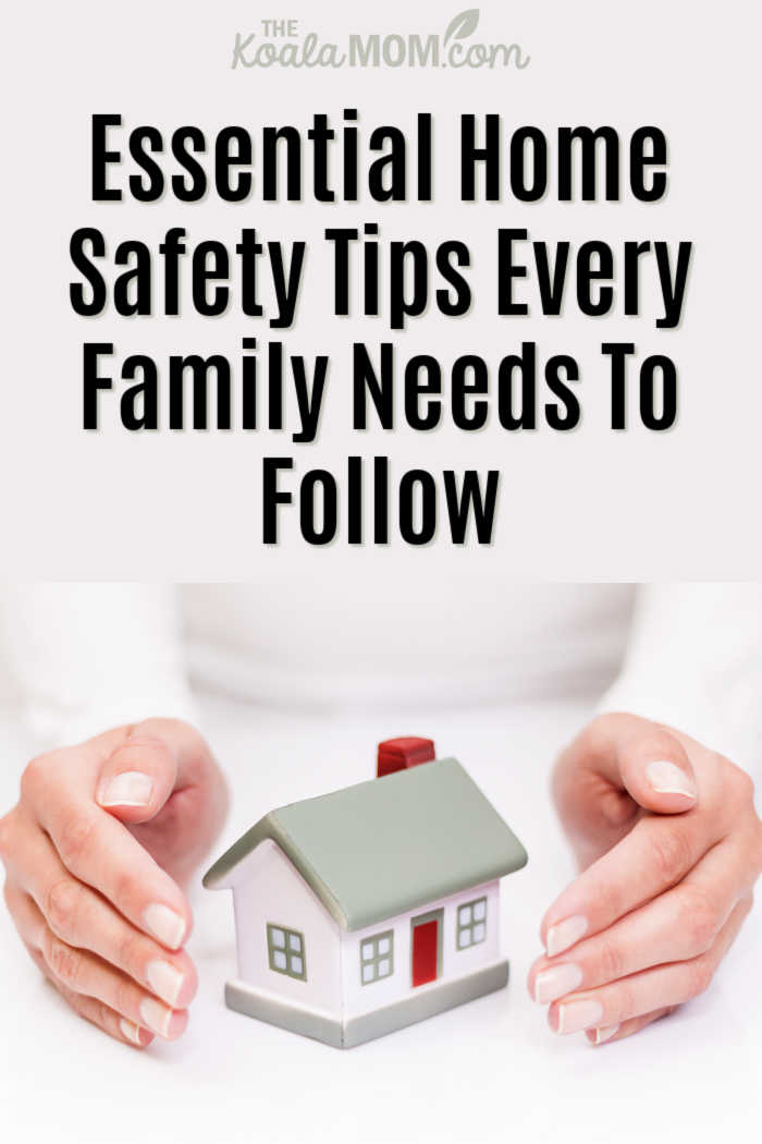 Essential Home Safety Tips Every Family Needs To Follow. Photo of hands around model house via Depositphotos.