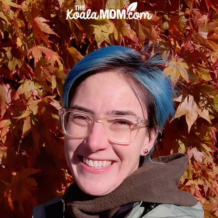 Bonnie Way standing in front of an orange maple tree.