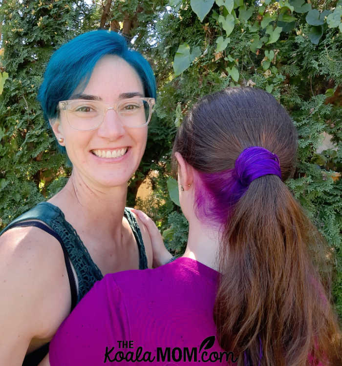Mother and daughter hair dye - mom with short blue hair and daughter with long purple and brown hair.