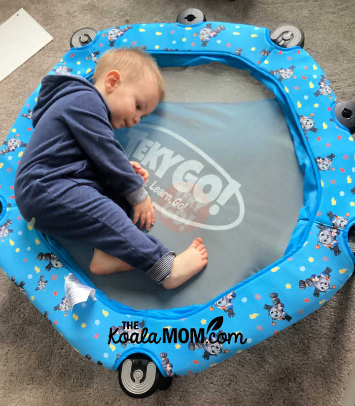 Cute toddler laying on his TekyGo! bouncer.
