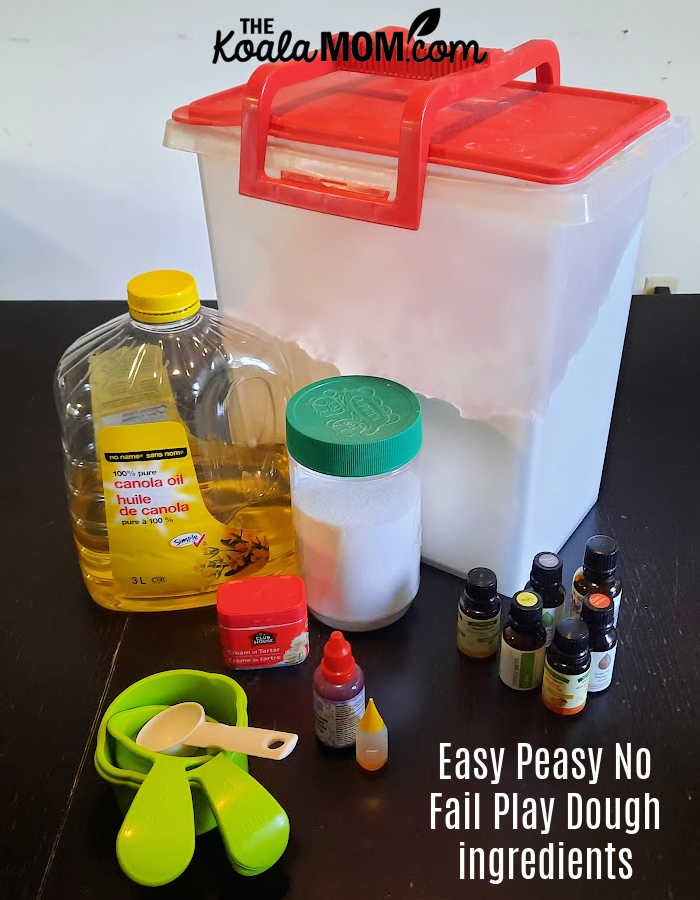 Easy peasy no fail homemade play dough recipe ingredients: flour, canola oil, salt, cream of tartar, essential oils, food colouring, and mixing cups and spoons.