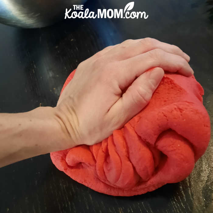 Mom kneading a batch of no fail red play dough.