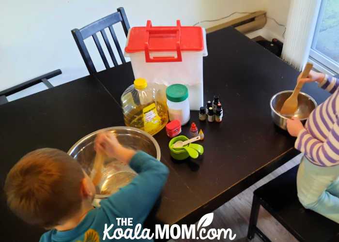 Two kids helping make homemade play dough.