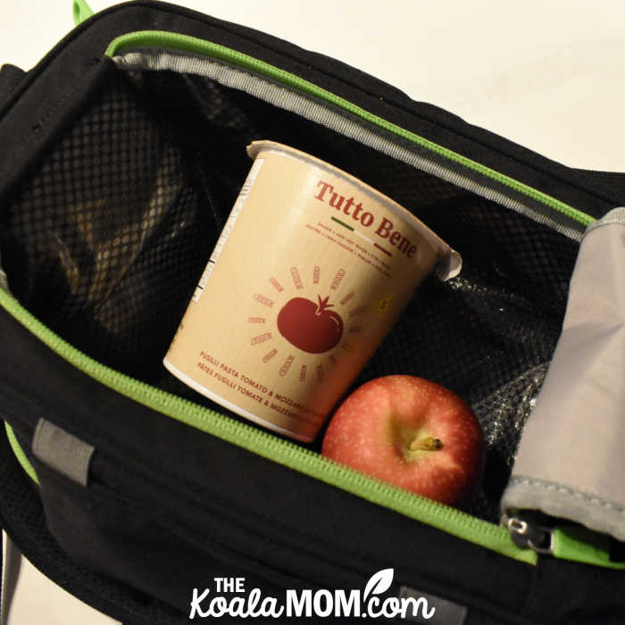 Noodles and apple packed in a lunch bag.