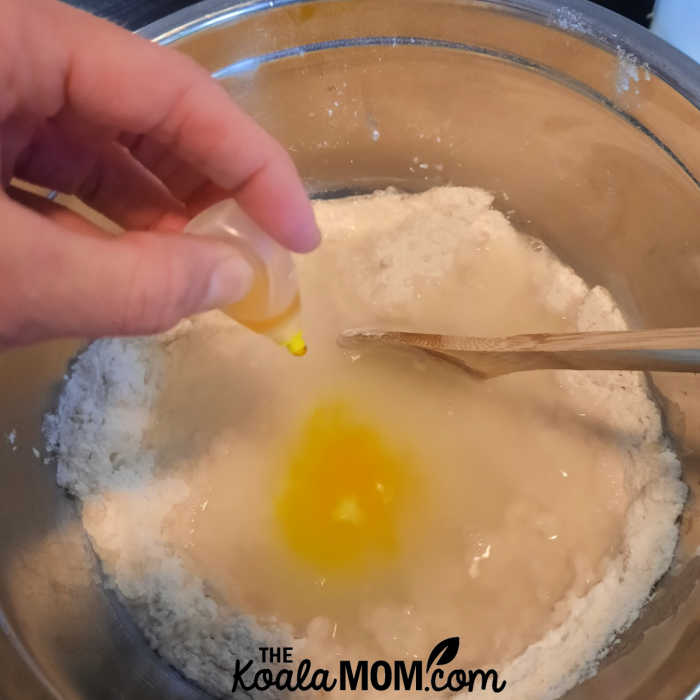 Adding yellow food colouring to our batch of home made no fail play dough.