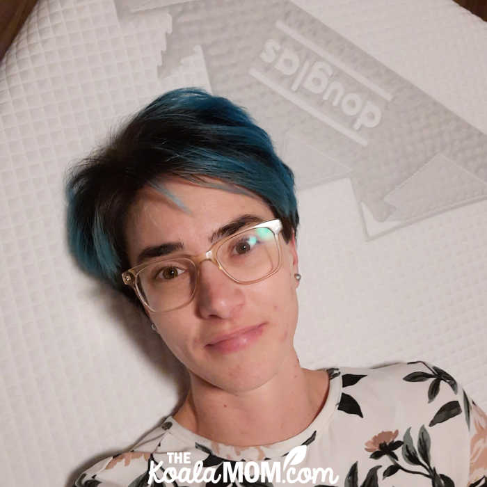 Mom takes a selfie while laying on her new Douglas mattress-in-a-box.