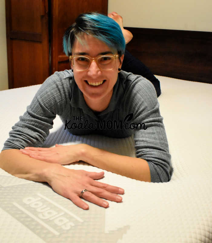 Happy mom laying on her new Douglas mattress.