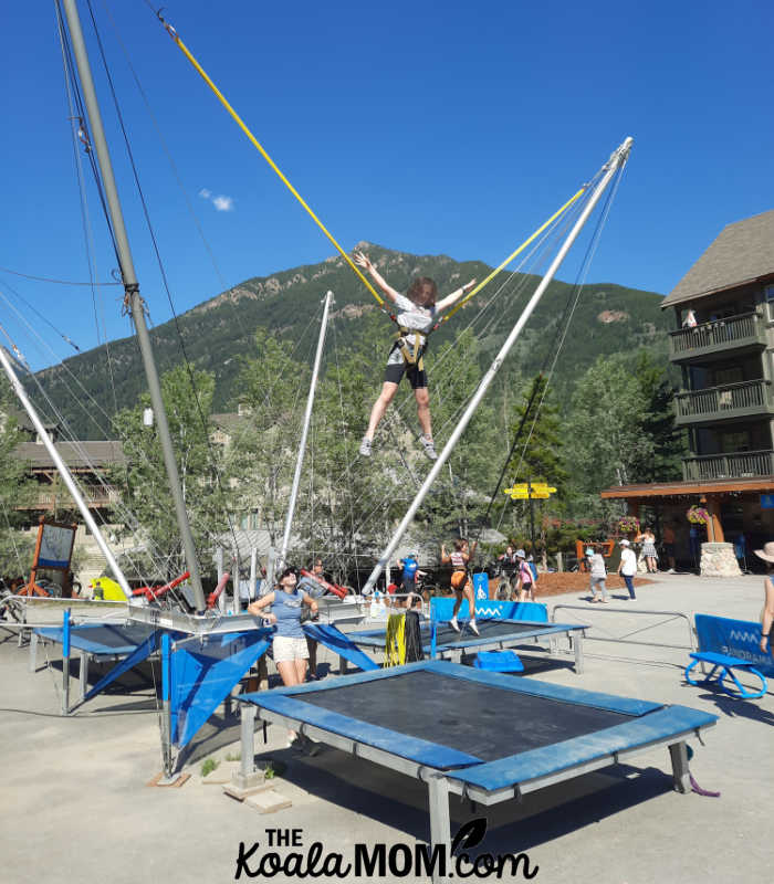 Teenager having fun bungee jumping on a trampoline.