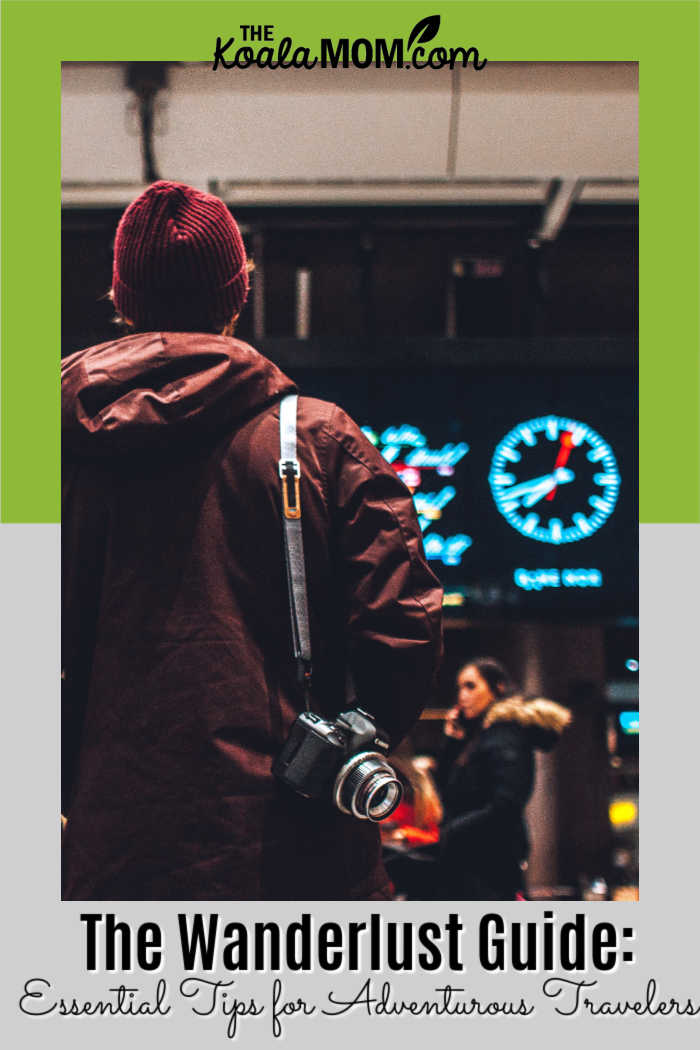The Wanderlust Guide: Essential Tips for Adventurous Travelers. Photo of person looking at flight times in an airport by Erik Odiin on Unsplash