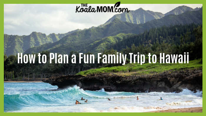 How To Plan A Fun Family Trip To Hawaii. Photo of people swimming on a beach in Hawaii with mountains above by Luke McKeown on Unsplash