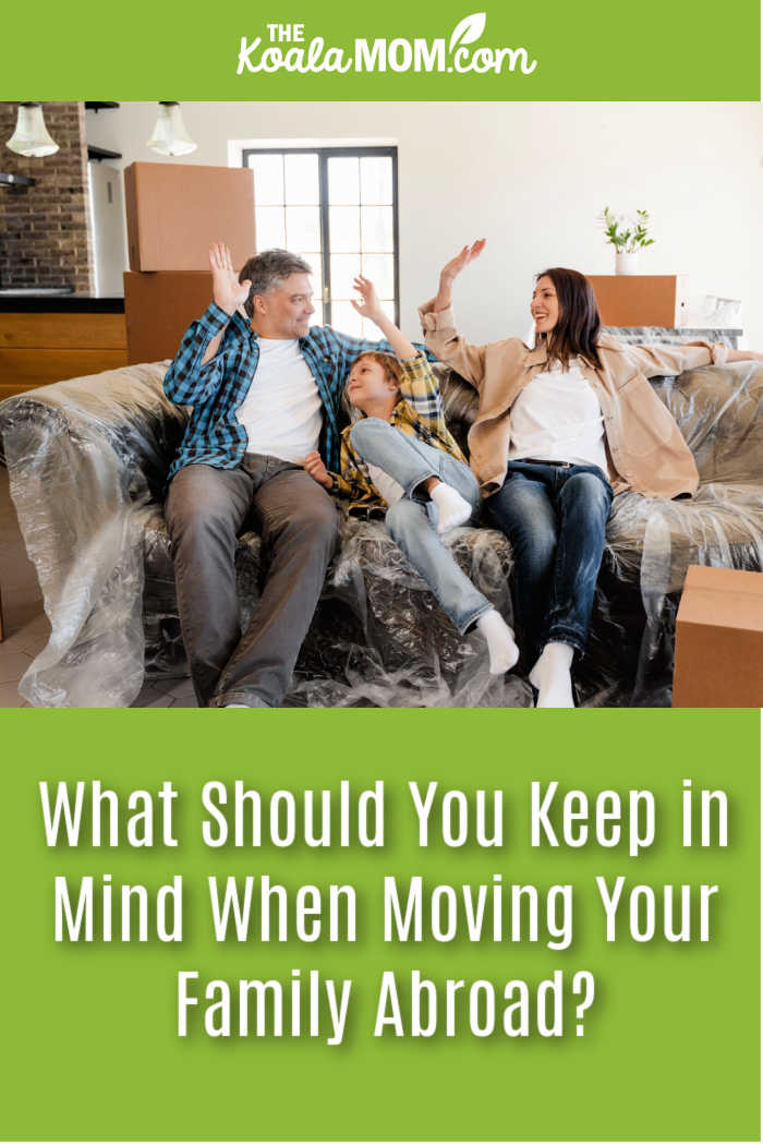 What Should You Keep in Mind When Moving Your Family Abroad? Photo of happy family sitting on couch covered in plastic by MART PRODUCTION via Pexels.