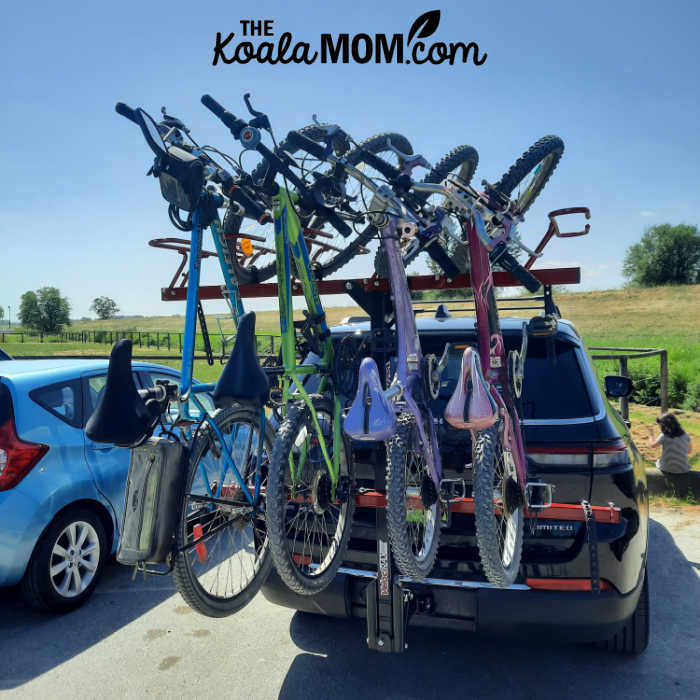 Five bikes racked on a Velocirax on a Jeep.