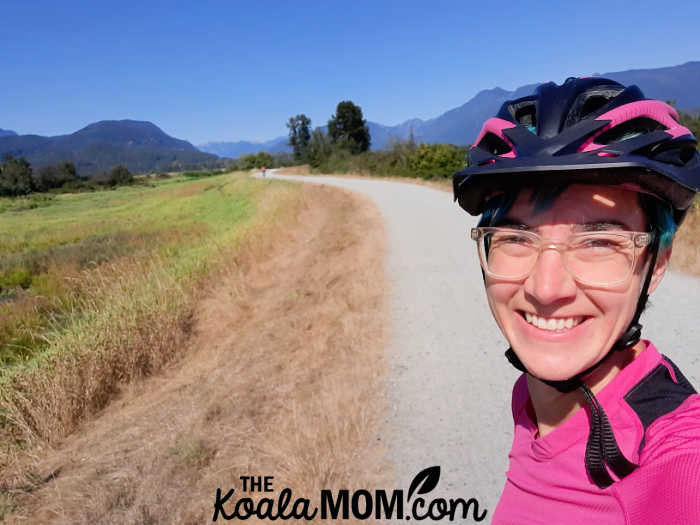 Happy cyclist on a sunny day on the dike trails in Maple Ridge.