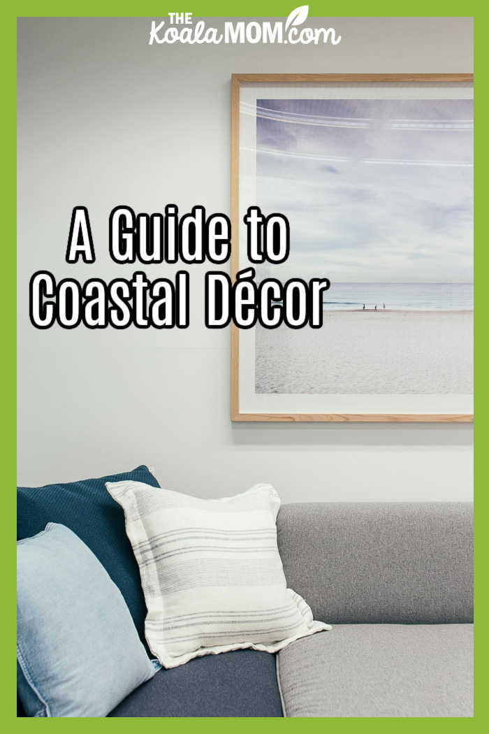 A Guide to Coastal Décor. Photo of living room in greys / blues with beach photo above couch by Rachel Claire via Pexels.
