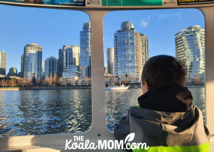 Boy looking out the window of the ferry on Vancouver's False Creek. Photo by Bonnie Way.