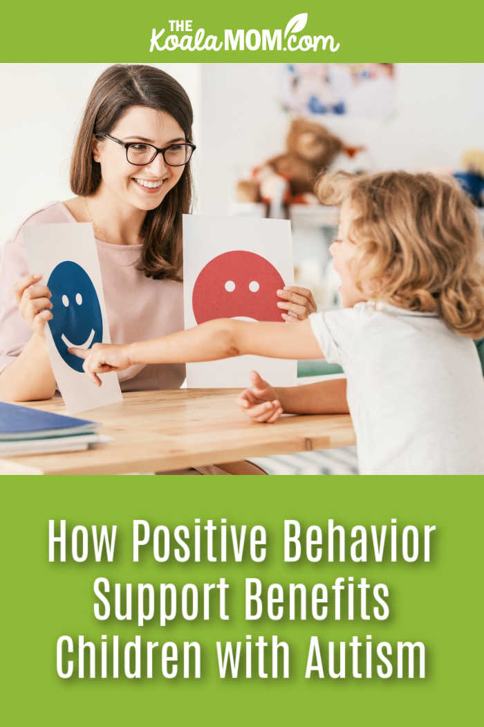 How Positive Behavior Support Benefits Children With Autism. Photo of smiling female therapist holding up two emoji faces for a girl with autism via stock photo site.