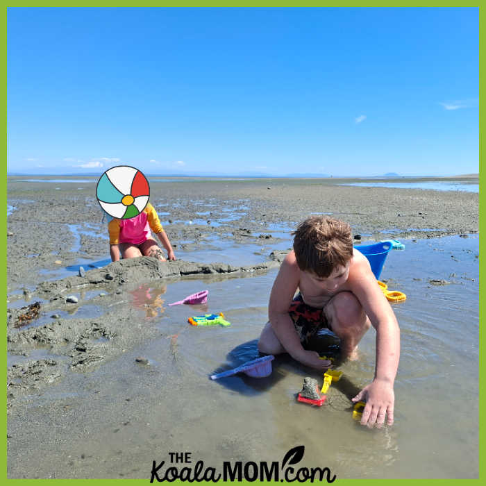 Boy plays at each with beach toys. Photo by Bonnie Way.