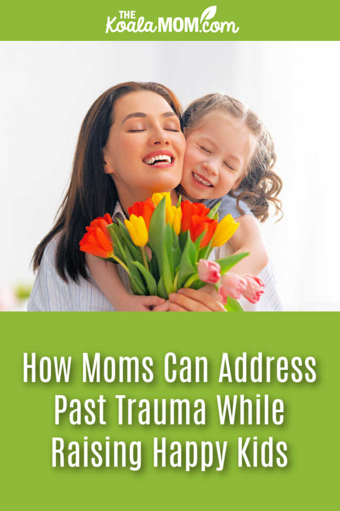 How Moms Can Address Past Trauma While Raising Happy Kids. Stock photo of happy mom holding tulips while her daughter hugs her from behind.