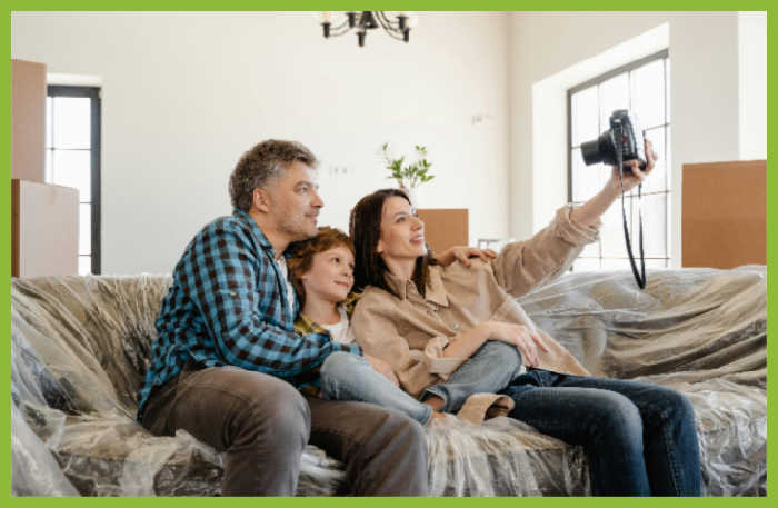 Photo of a mom, dad, and son sitting on a couch taking a selfie together by MART PRODUCTION via Pexels.