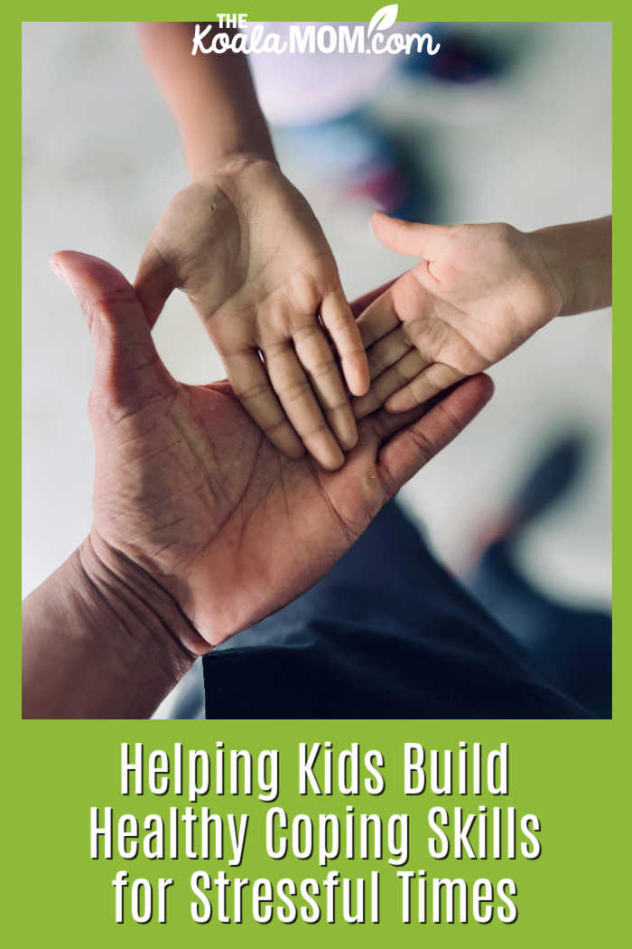 Helping Kids Build Healthy Coping Skills for Stressful Times. Photo of adult hand with two kids' hands open inside it by Chris John via Pexels.