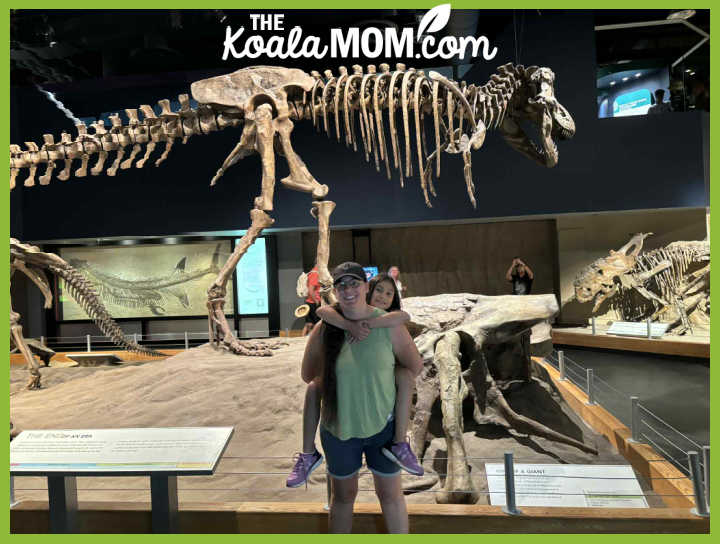 Shelby Emmanuels piggy-backing her daughter at the Royal Tyrell Museum in Drumhellar, Alberta.