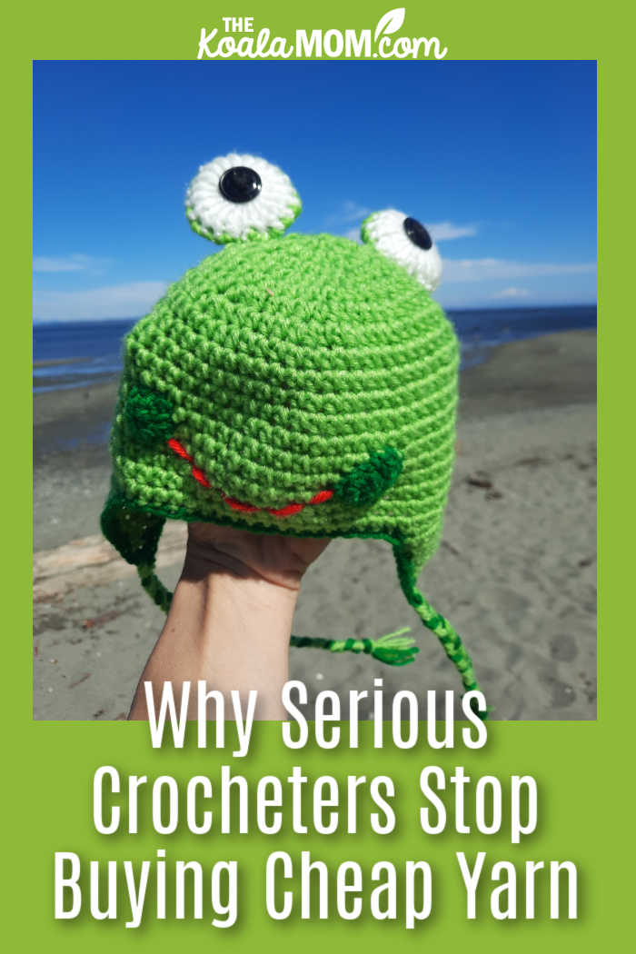 Why Serious Crocheters Eventually Stop Buying Cheap Yarn. Photo of crocheted "froggy" hat held on hand with a beach background by Bonnie Way.