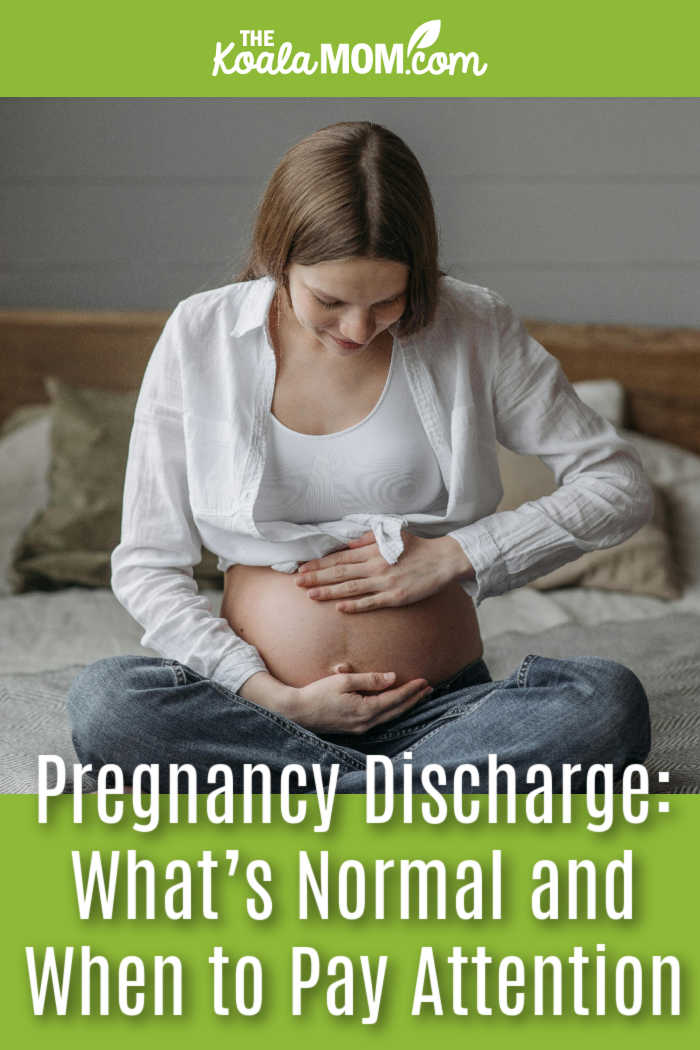 Pregnancy Discharge: What’s Normal and When to Pay Attention. Photo of young woman sitting cross-legged on her bed with her hands around her pregnant tummy by Pavel Danilyuk via Pexels.