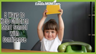 5 Ways to Help Children Start School with Confidence. Photo of smiling girl holding her notebook in the air by freepik.