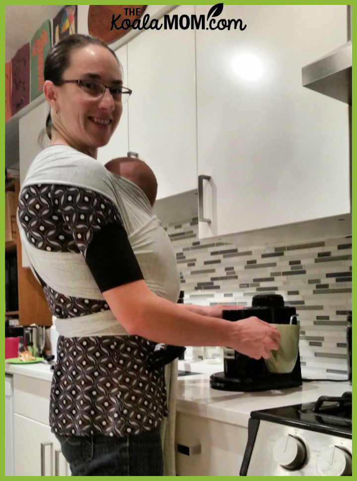 Bonnie Way makes a coffee while carrying her youngest baby in a wrap.