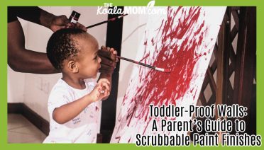 Toddler-Proof Walls: A Parent’s Guide to Scrubbable Paint Finishes. Photo of dad watching toddler son spread red paint over a canvas by kajanja brand via Pexels.