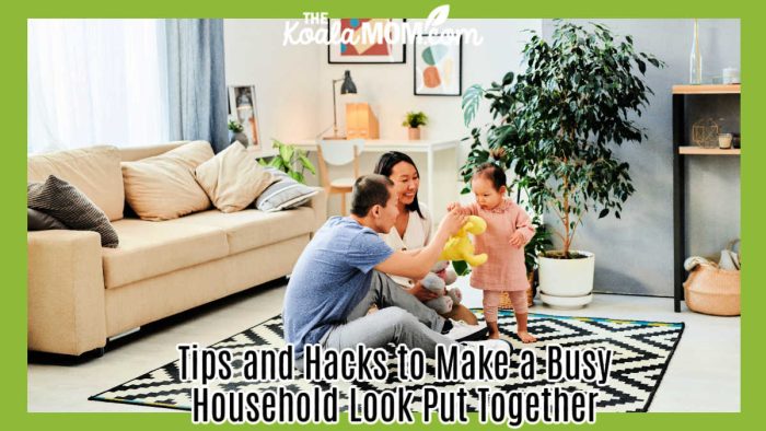 Tips and Hacks to Make a Busy Household Look Put Together. Photo of mom and dad sitting on a rug in their living room, playing with toddler, by ShotPot via Pexels.
