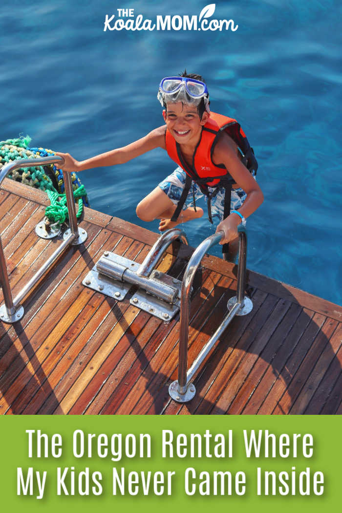 The Oregon Rental Where My Kids Never Came Inside. Photo of smiling boy climbing up ladder onto a dock, wearing swim goggles and a lifejacket, by Kareem Elkattan via Pexels.