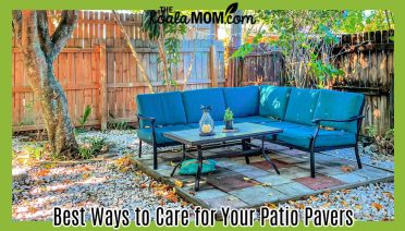 Best Ways to Care for Your Patio Pavers. Photo of teal outdoor couch with a glass coffee table on a raised stone patio with fence around it and trees overhead by Noriely Fernandez via Pexels.